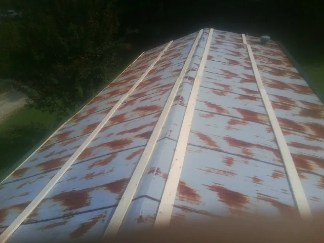 Rusted metal roof panels with new wood purlins before replacement — Storm Damage Roof Repair in Somers Point by Roofing Brothers
